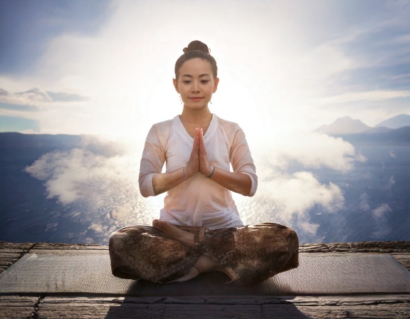 Firefly Kundalini Yoga and prayer concept; yogi woman practices at mid day 74029